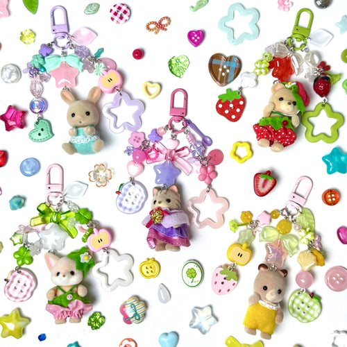 Collection of colorful keychains and charms on a white background