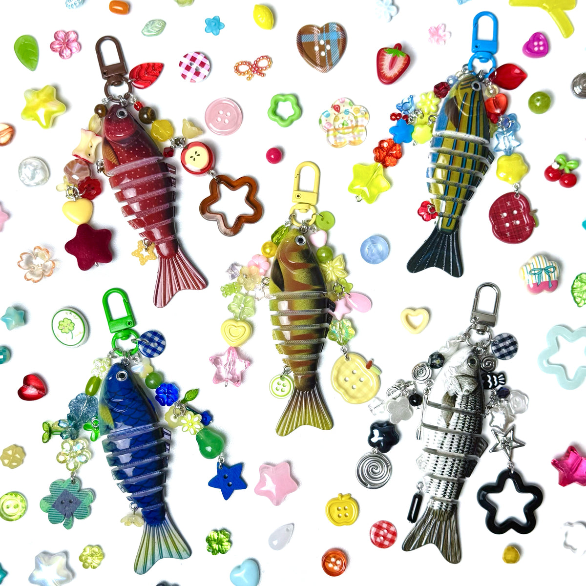 Colorful fish-shaped keychains with various charms on a patterned background