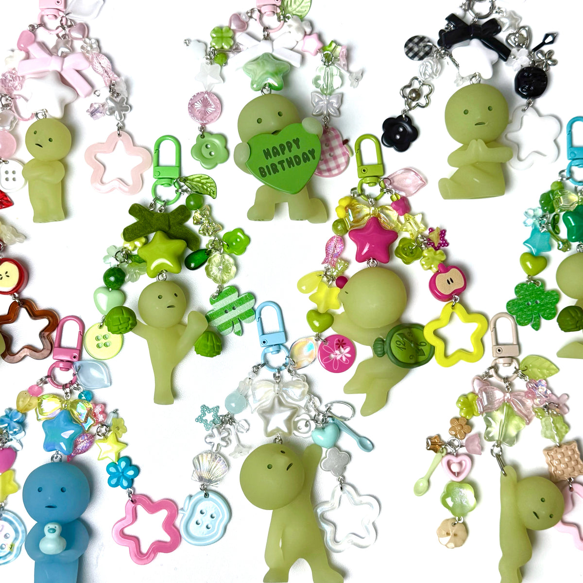 Colorful keychains with various charms on a white background