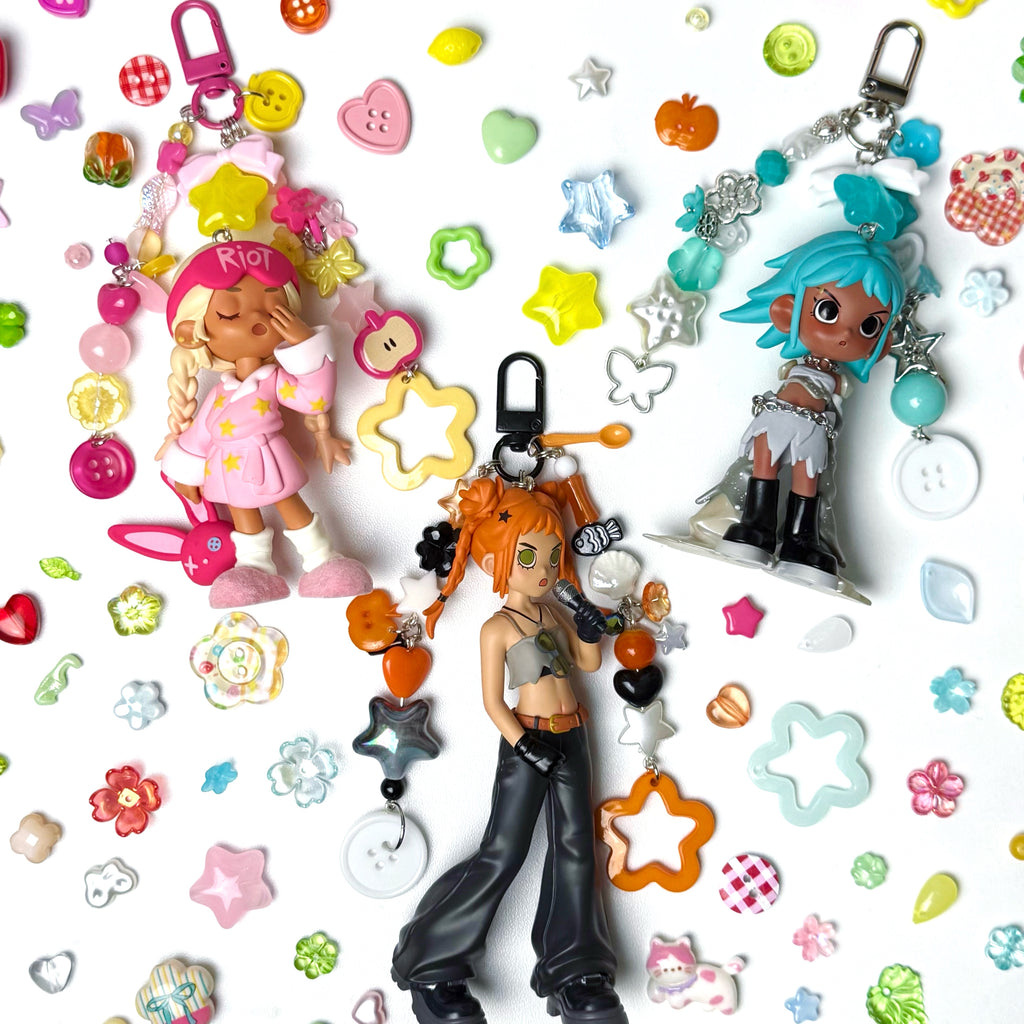 Collection of 3 colorful keychains and figurines on a patterned background