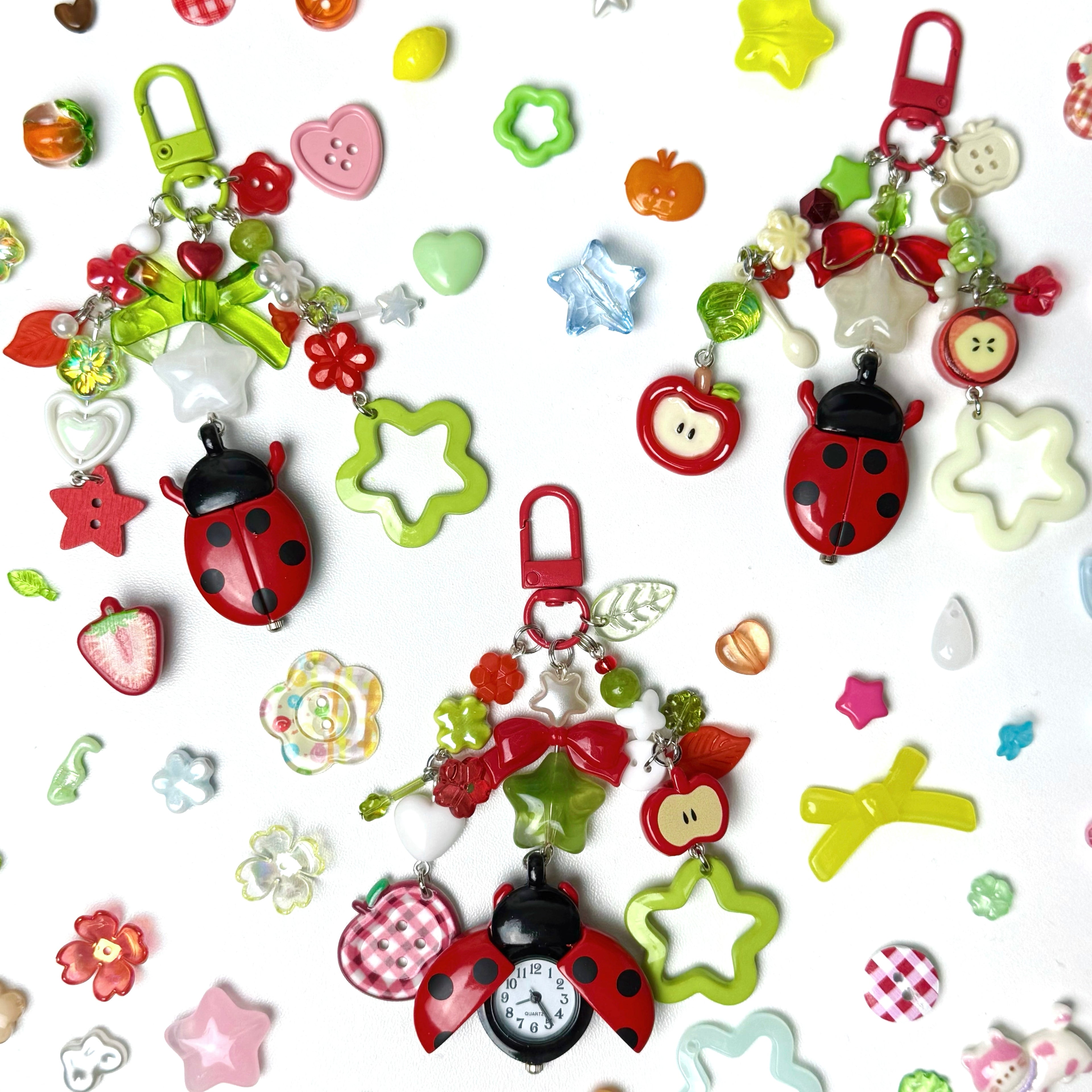 Colorful keychains with ladybugs, stars, and other shapes on a white background