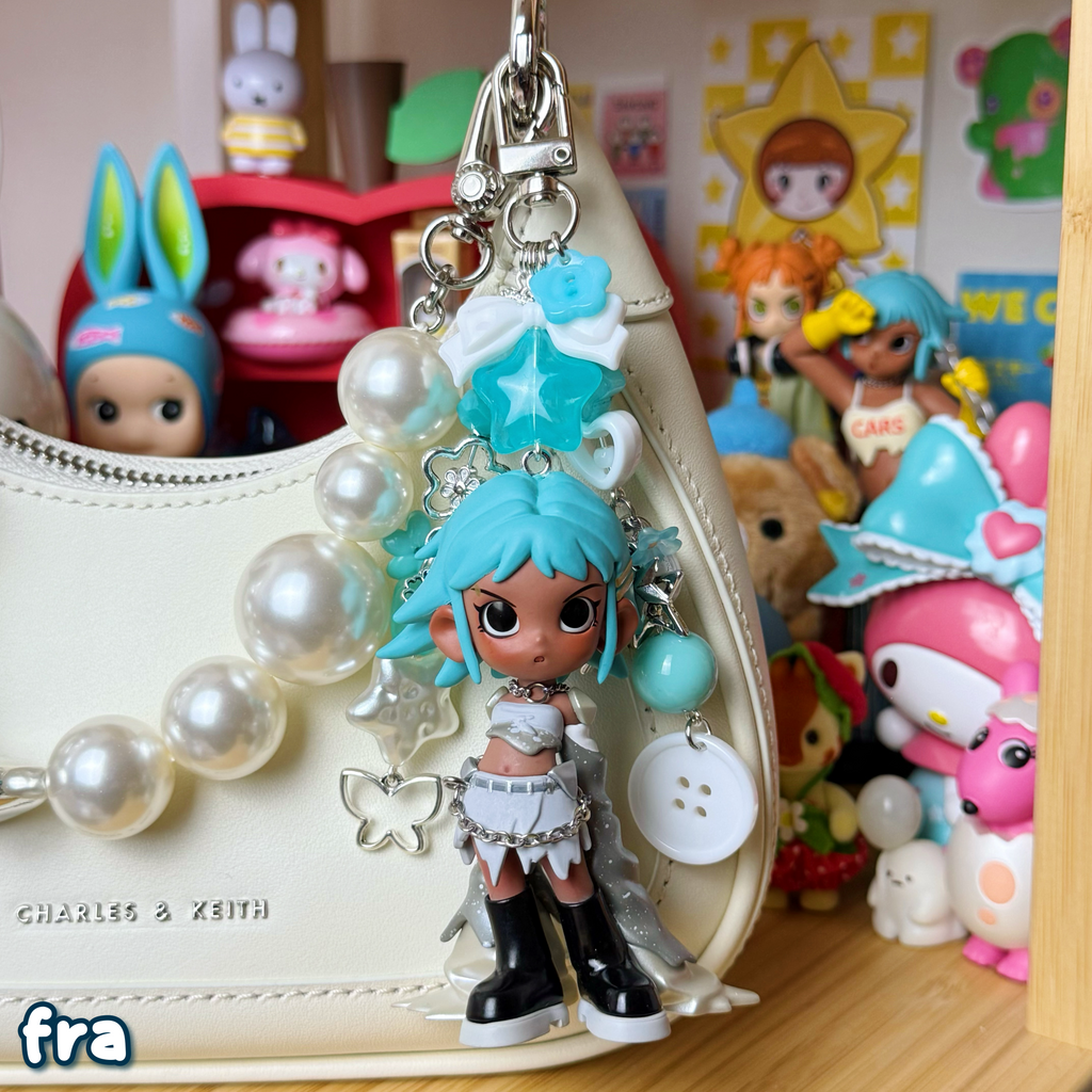 frank keychain on a purse; white, silver, & teal