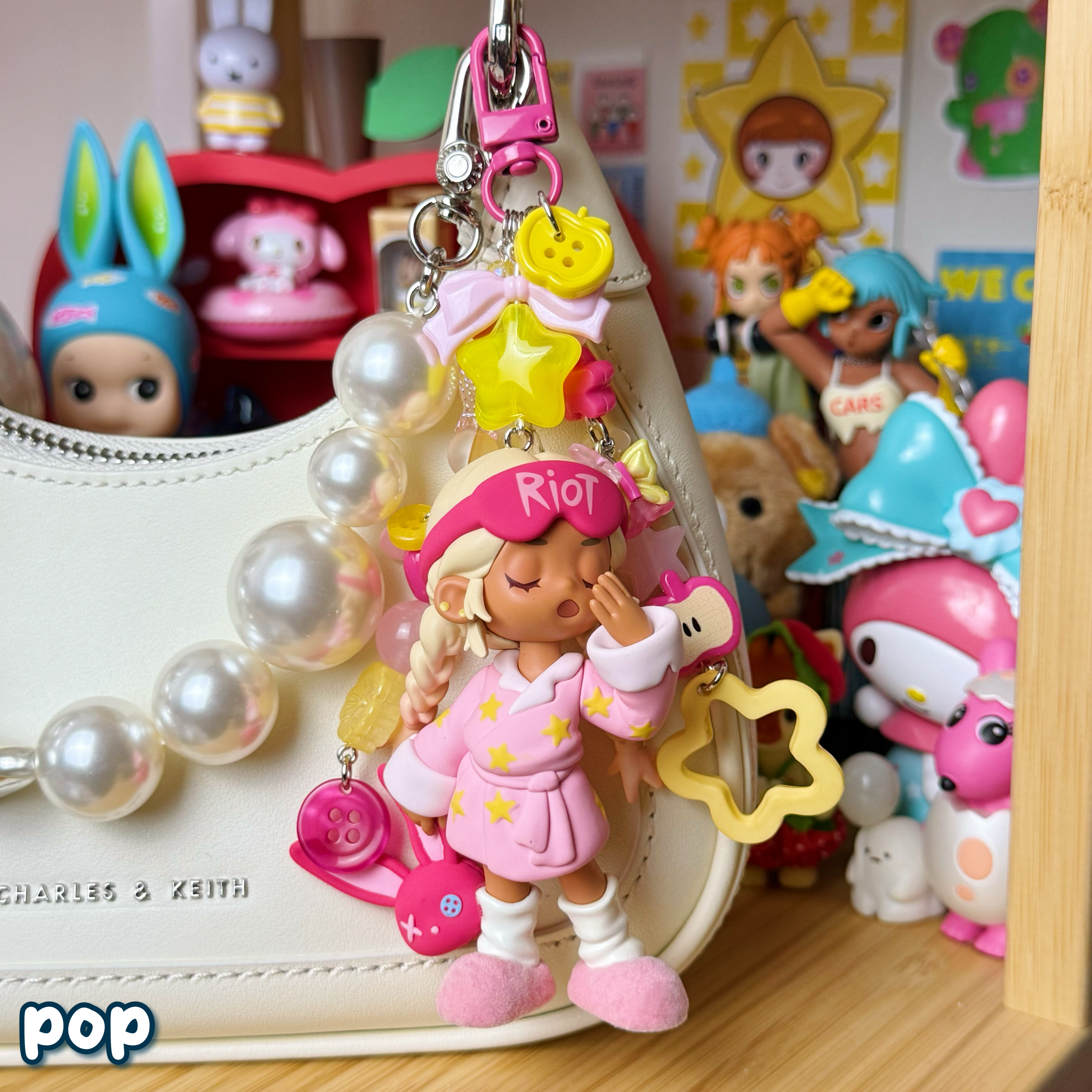 pop keychain on a purse; pink, hot pink, & yellow