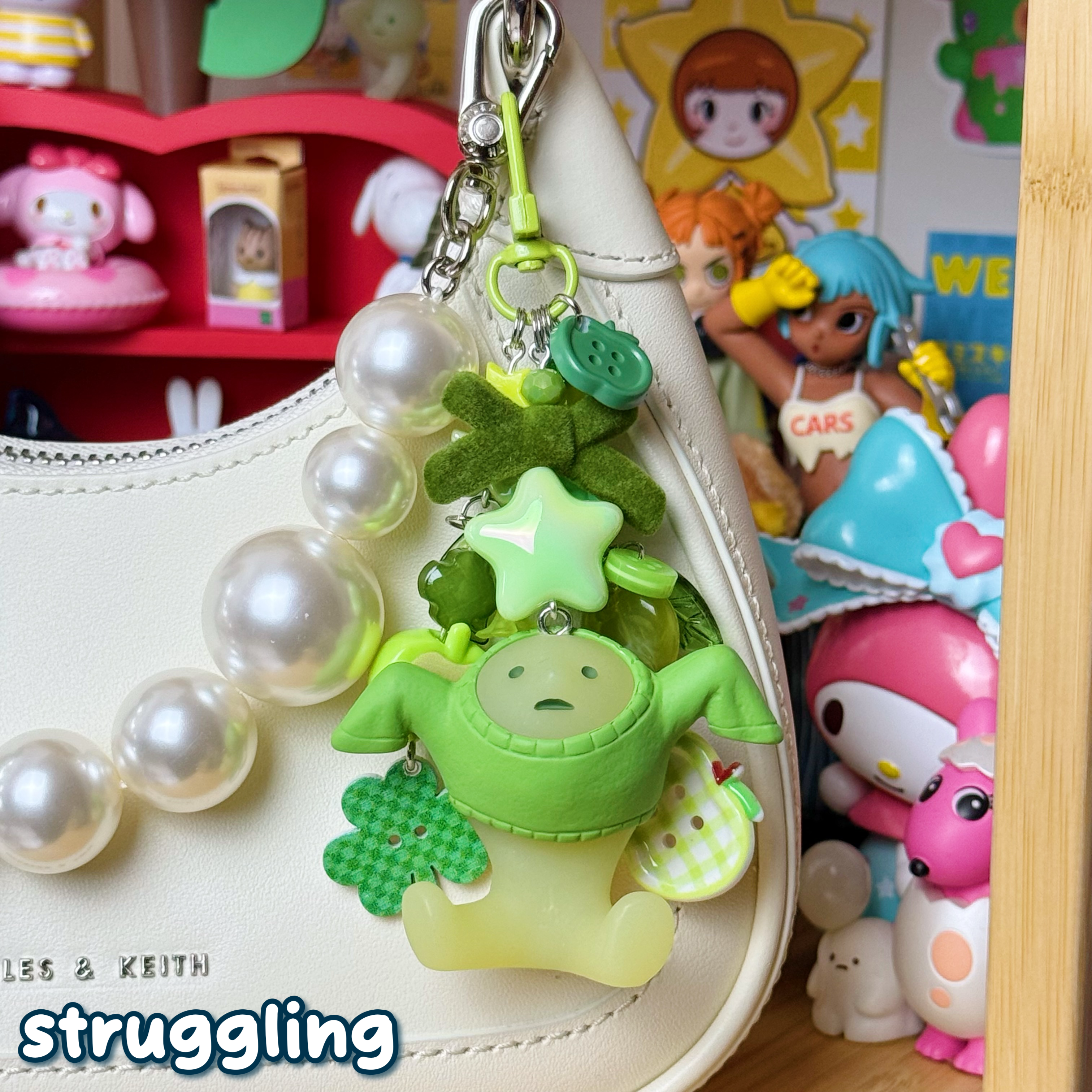 monochrome green struggling smiski keychain