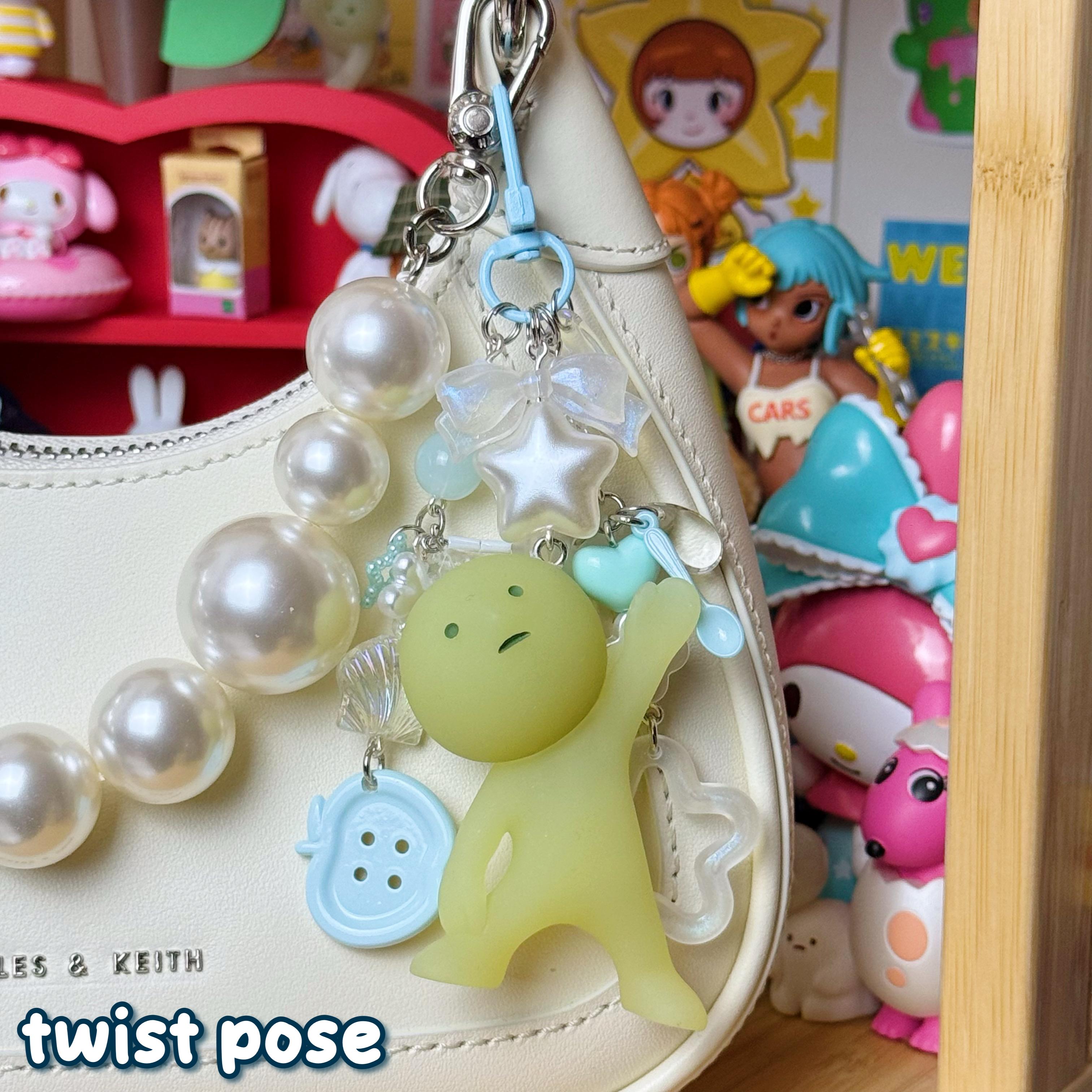 light blue, clear, and white twist pose smiski keychain