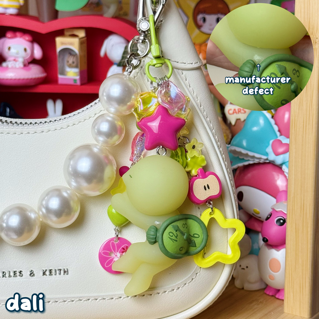 magenta, green, & yellow dali smiski keychain with small manufacturer defect