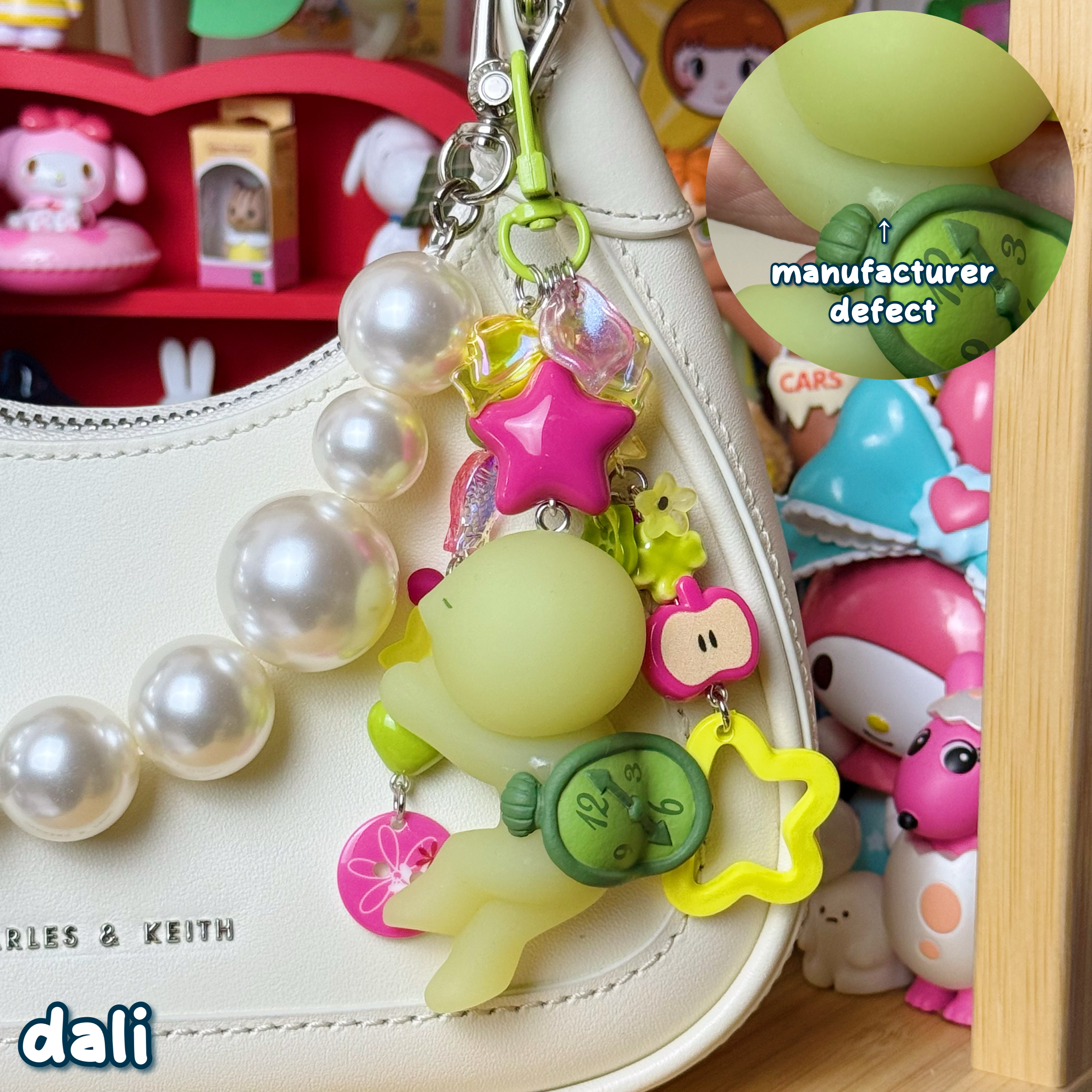 magenta, green, & yellow dali smiski keychain with small manufacturer defect